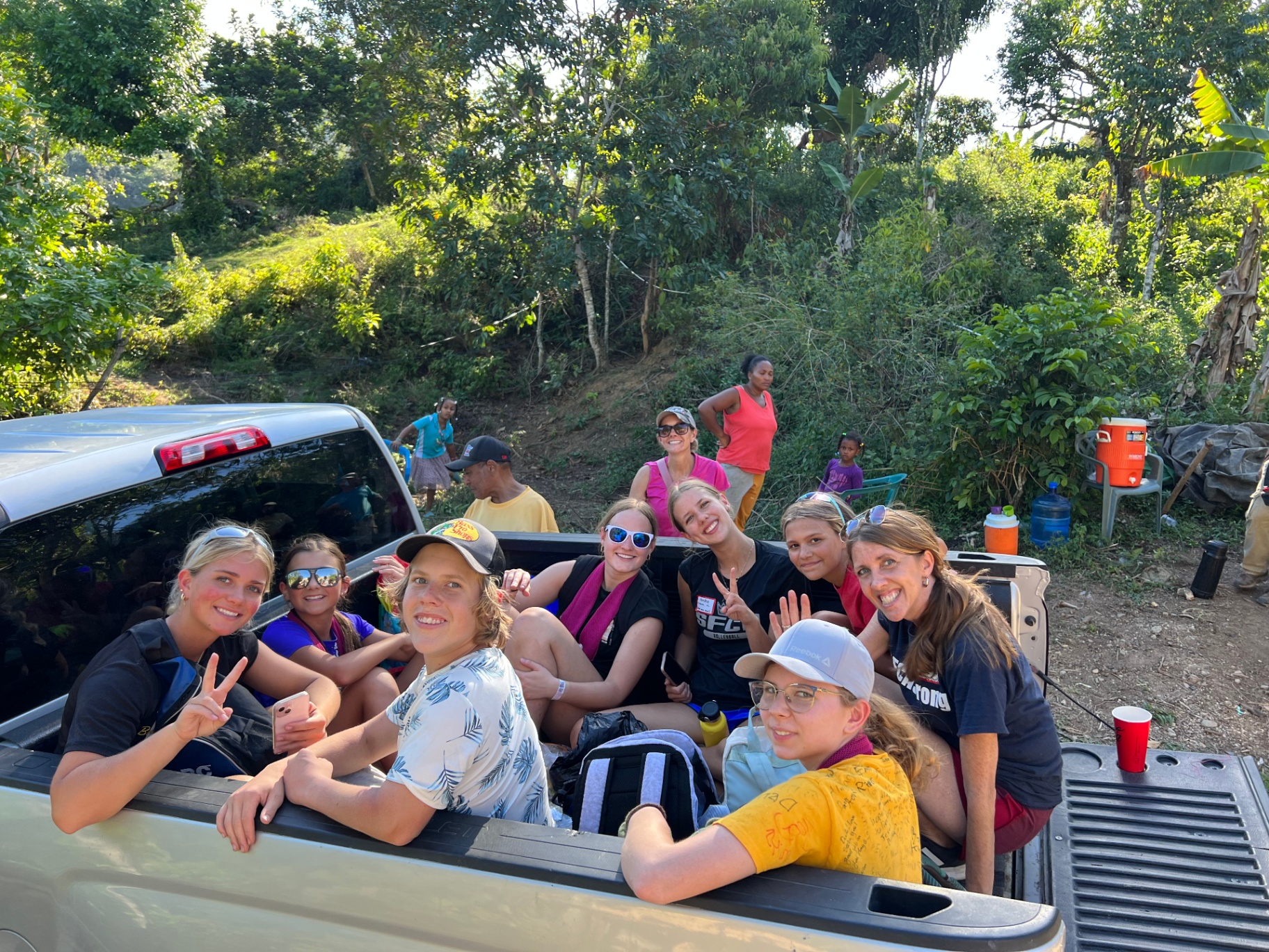 Team riding together in the back of a truck through the countryside