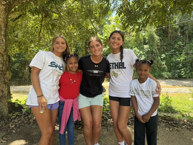 Volunteers spending time with elementary age kids at a school in San Cristóbal