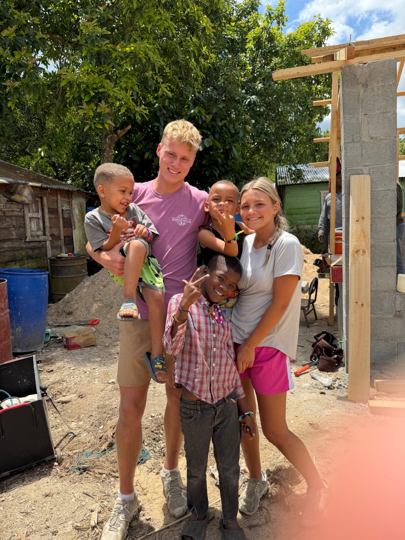 Young volunteers spending time with local children at the build site