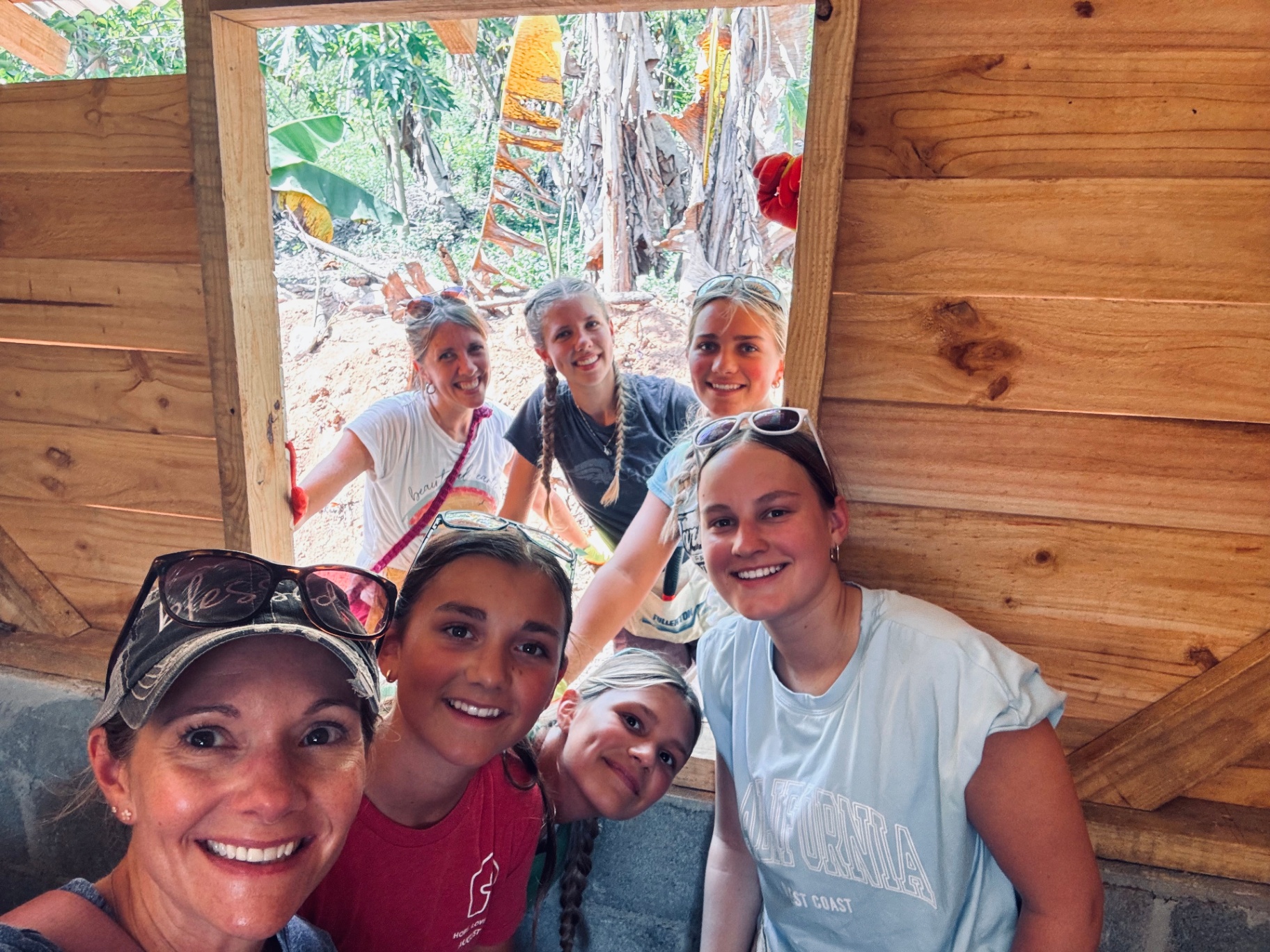 Volunteers smiling together inside a finished home