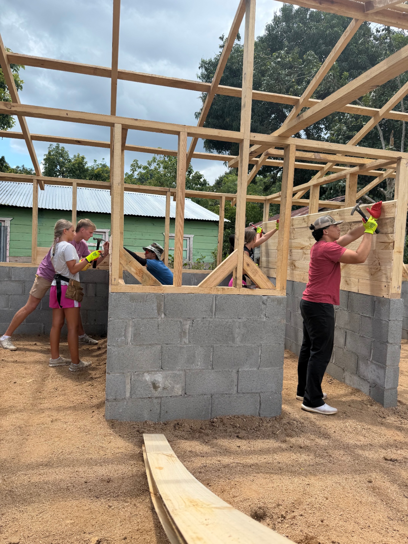 Volunteers framing the walls of a home under construction in San Cristóbal